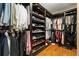 Custom walk-in closet with dark wood shelving and ample storage space at 335 Birkdale Dr, Fayetteville, GA 30215