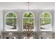 Stunning wall of arched windows offering abundant natural light and scenic views at 335 Birkdale Dr, Fayetteville, GA 30215