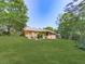 View of the back of the house, deck, and expansive green lawn at 4307 Smithsonia Ct, Tucker, GA 30084