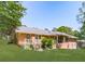 Expansive backyard featuring a brick house, wooden deck with stairs, and well-maintained lawn surrounded by mature trees at 4307 Smithsonia Ct, Tucker, GA 30084