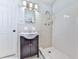 Compact bathroom featuring a single sink vanity, a tiled shower and neutral décor at 4307 Smithsonia Ct, Tucker, GA 30084