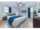 This is a bright bedroom with a ceiling fan, hardwood floors, and blue accents at 4307 Smithsonia Ct, Tucker, GA 30084