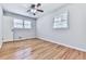 Bright bedroom with hardwood floors, natural light, and a ceiling fan offers a comfortable and inviting space at 4307 Smithsonia Ct, Tucker, GA 30084