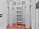 Walk-in closet with shelves and hanging racks for optimal storage at 4307 Smithsonia Ct, Tucker, GA 30084