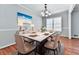 Bright dining room with hardwood floors, neutral walls, and modern light fixture at 4307 Smithsonia Ct, Tucker, GA 30084