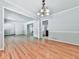 Open concept dining room showing hardwood floors and access to multiple rooms at 4307 Smithsonia Ct, Tucker, GA 30084