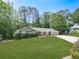 Well-maintained one-story home with beautiful front yard, manicured shrubs, and an extended driveway leading to the garage at 4307 Smithsonia Ct, Tucker, GA 30084