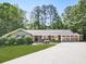Charming single-story home with lush front lawn, mature landscaping, and a three-car garage, offering great curb appeal at 4307 Smithsonia Ct, Tucker, GA 30084