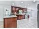Kitchen boasts dark wood cabinetry, stainless appliances, and neutral tile flooring at 4307 Smithsonia Ct, Tucker, GA 30084