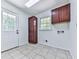 Functional laundry room with tile flooring, storage cabinets, and convenient access to the backyard at 4307 Smithsonia Ct, Tucker, GA 30084