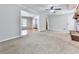 Spacious carpeted living room featuring a brick fireplace and an open layout leading to other rooms at 4307 Smithsonia Ct, Tucker, GA 30084