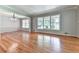 Spacious living room with hardwood floors and large windows providing plenty of natural light at 4307 Smithsonia Ct, Tucker, GA 30084