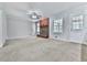 Bright living room with a brick fireplace, ceiling fan, and large windows offering natural light at 4307 Smithsonia Ct, Tucker, GA 30084