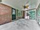 View of the screened porch with brick wall, fan and an entrance door at 4307 Smithsonia Ct, Tucker, GA 30084