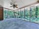 A screened porch with a ceiling fan, surrounded by the beautiful outdoors at 4307 Smithsonia Ct, Tucker, GA 30084