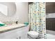 Bathroom with a colorful shower curtain, white vanity, and granite countertop at 1084 Regent Sw St, Atlanta, GA 30310