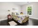 Cozy bedroom with hardwood floors, neutral walls, and a sunny window at 1084 Regent Sw St, Atlanta, GA 30310