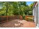 Exterior of expansive deck with wood railing overlooking the green yard and mature trees on the property at 1084 Regent Sw St, Atlanta, GA 30310