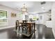 Bright dining area with dark wood floors, lots of natural light, and open to modern kitchen at 1084 Regent Sw St, Atlanta, GA 30310