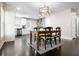 Open dining area with a wooden table, decorative light fixture, and views into the modern kitchen at 1084 Regent Sw St, Atlanta, GA 30310