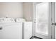 Clean laundry room with white washer and dryer, plus a door to outside for easy access at 1084 Regent Sw St, Atlanta, GA 30310