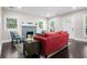 Comfortable living room featuring a brick fireplace, dark wood floors, and abundant natural light at 1084 Regent Sw St, Atlanta, GA 30310