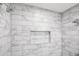 Close up of modern shower with marble-look tile and built-in niche at 1084 Regent Sw St, Atlanta, GA 30310