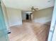 Open-concept living space with a ceiling fan and an open doorway to a kitchen at 1794 Blossom Ln, Austell, GA 30168