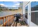 Outdoor balcony features wood flooring with a barbecue and seating; great for relaxing and enjoying outdoor living at 200 High Creek Dr, Roswell, GA 30076