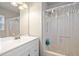 A full bathroom features a shower with a shower curtain and a vanity with a mirror at 200 High Creek Dr, Roswell, GA 30076