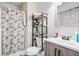 This full bathroom offers essential amenities, including a patterned shower curtain and sleek vanity at 200 High Creek Dr, Roswell, GA 30076