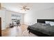Bright bedroom with a ceiling fan, a large window, and neutral walls is a perfect space to relax at 200 High Creek Dr, Roswell, GA 30076