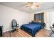 The well-lit bedroom is adorned with a ceiling fan, a bed, and a modern computer chair at 200 High Creek Dr, Roswell, GA 30076