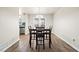 An inviting dining area features a modern chandelier and access to the backyard through double doors at 200 High Creek Dr, Roswell, GA 30076