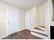 The entryway features beautiful hardwood flooring and leads to a staircase with white risers at 200 High Creek Dr, Roswell, GA 30076