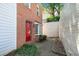 Brick two-story townhome featuring a red door and exterior window at 200 High Creek Dr, Roswell, GA 30076