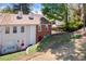 Townhome exterior featuring a brick and siding facade plus mature landscaping at 200 High Creek Dr, Roswell, GA 30076