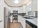 Bright kitchen featuring white cabinets, stainless steel appliances, and modern backsplash at 200 High Creek Dr, Roswell, GA 30076