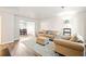 Inviting living room with neutral tones, plush seating, and wood floors, that open layout to dining room at 200 High Creek Dr, Roswell, GA 30076