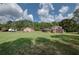 Expansive backyard featuring lush greenery, a trailer, and outbuildings, offering ample space for outdoor activities at 4345 Commodore Rd, Powder Springs, GA 30127