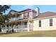 Charming two-story home featuring a spacious porch, red shutters, and ample natural light at 4345 Commodore Rd, Powder Springs, GA 30127
