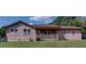 Single-story home with a covered porch and wood siding, showcasing a cozy and inviting facade at 4345 Commodore Rd, Powder Springs, GA 30127