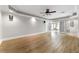Large basement with wood flooring, ceiling fan and double doors to an adjacent room at 562 Grassmeade Way, Snellville, GA 30078