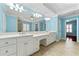 Bright bathroom with dual sink vanity, large mirror, and tile flooring at 562 Grassmeade Way, Snellville, GA 30078