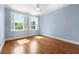 Bright bedroom with hardwood floors, large windows, and neutral paint, offers a serene space at 562 Grassmeade Way, Snellville, GA 30078