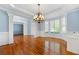 Charming dining room with hardwood floors, bright windows, and elegant crown molding at 562 Grassmeade Way, Snellville, GA 30078