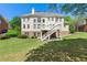 Exterior of home featuring a walkout basement, deck and well-manicured lawn at 562 Grassmeade Way, Snellville, GA 30078