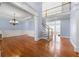 Open foyer boasts hardwood floors, staircase, and elegant chandelier creating a grand entrance at 562 Grassmeade Way, Snellville, GA 30078