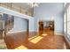 Open living room area with hardwood floors, high ceilings, stairway, and a view into the modern kitchen at 562 Grassmeade Way, Snellville, GA 30078