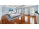 Staged main bedroom with hardwood floors, blue walls, white trim, and a tray ceiling at 562 Grassmeade Way, Snellville, GA 30078